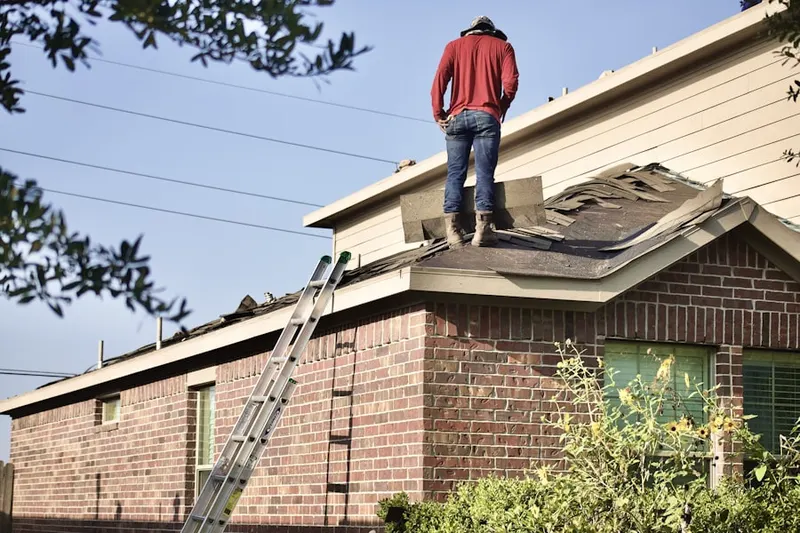 Professional roofer working on a residential roof in Bernards